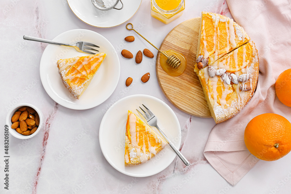 Tasty citrus cake with oranges on table