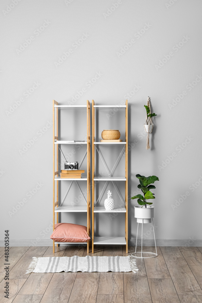 Shelving unit with decor near light wall