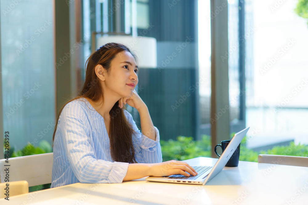 Portrait of a smart Asian girl freelance working online from home with laptop at home Living room an