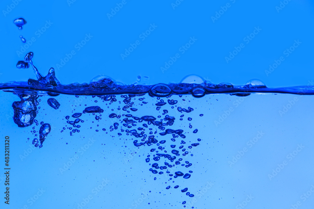 Clear water with air bubbles on blue background