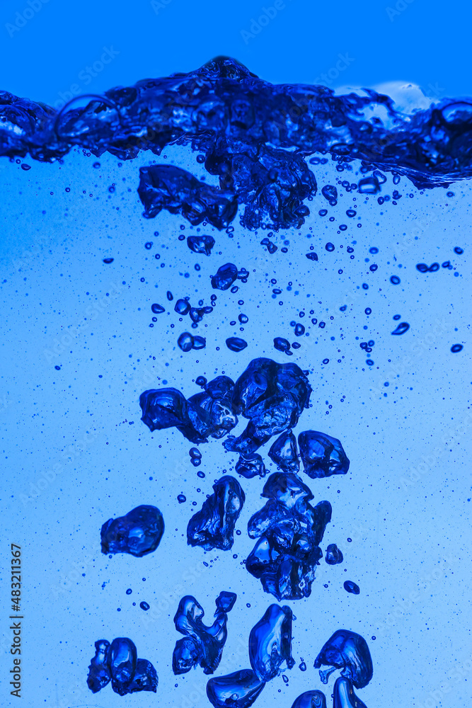 Clear water with air bubbles on blue background