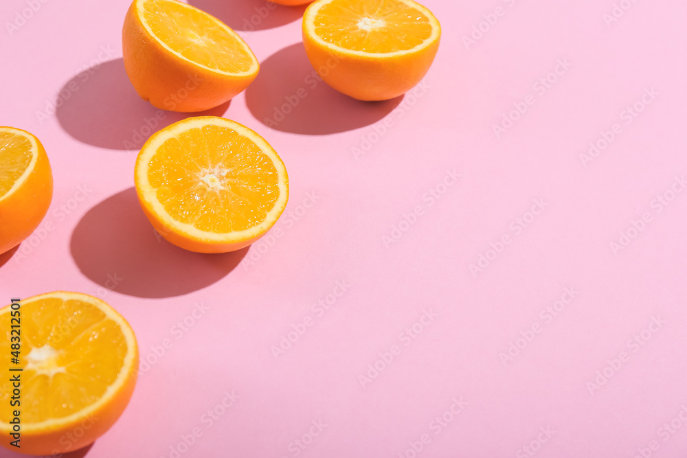 Fresh cut oranges on pink background, closeup