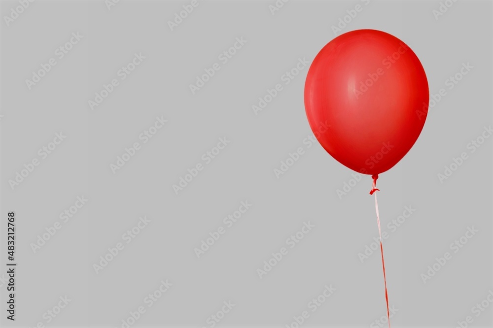 Red glossy flying balloon with ribbon. Helium balloon gift. Celebration concept. Holiday