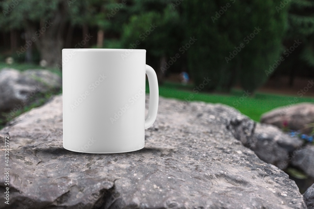 Blank enamel mug, camping cup mockup in wild nature.