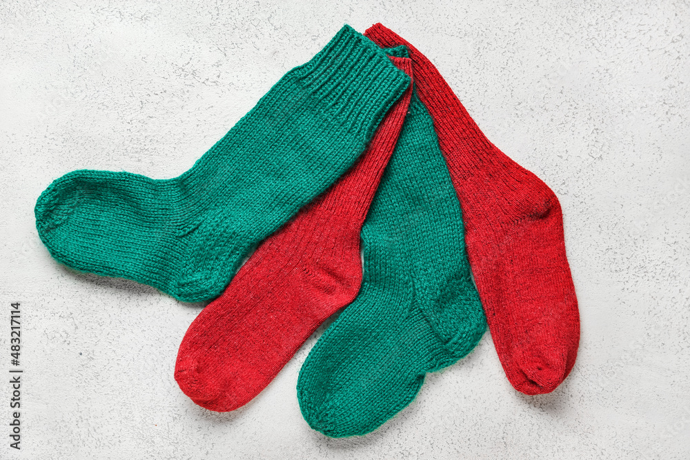 Warm knitted socks on light background