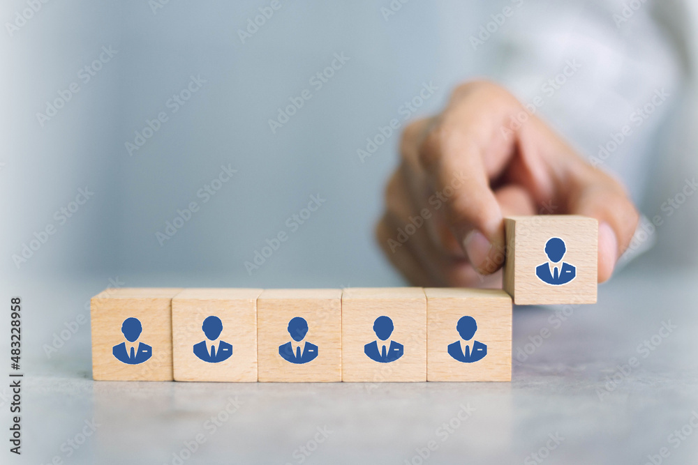 Recruiter complete team represented by wooden cube by one leader person (CEO) and icon,human resourc