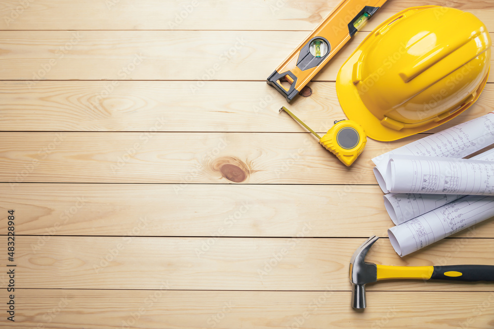 Work safety. Standard Construction site protective equipment on  top view wooden background, flat la