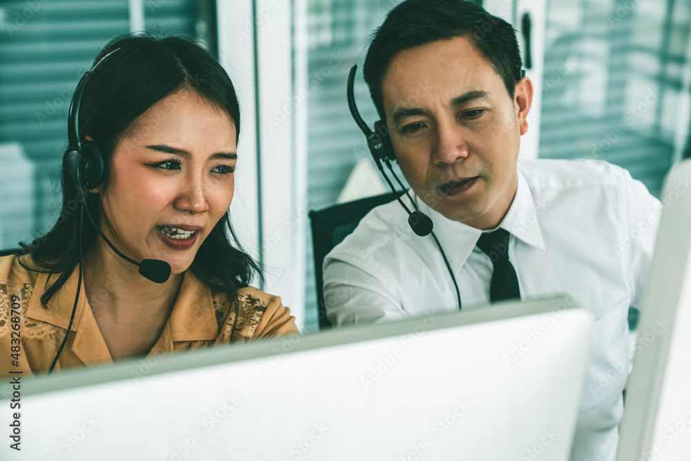 Business people wearing headset working actively in office . Call center, telemarketing, customer su