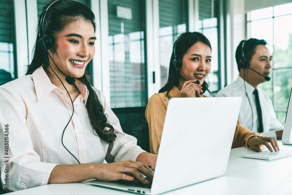 Business people wearing headset working actively in office . Call center, telemarketing, customer su