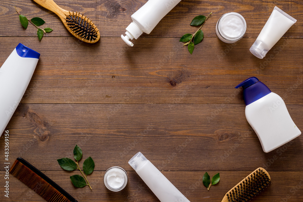 Flat lay of cosmetics for hair care with comb