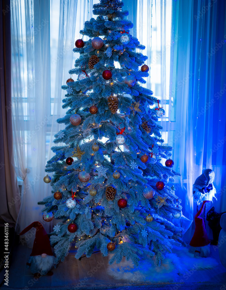 Beautiful Christmas tree with lights and ribbons. Amazing fir tree decorated with Christmas balls ne