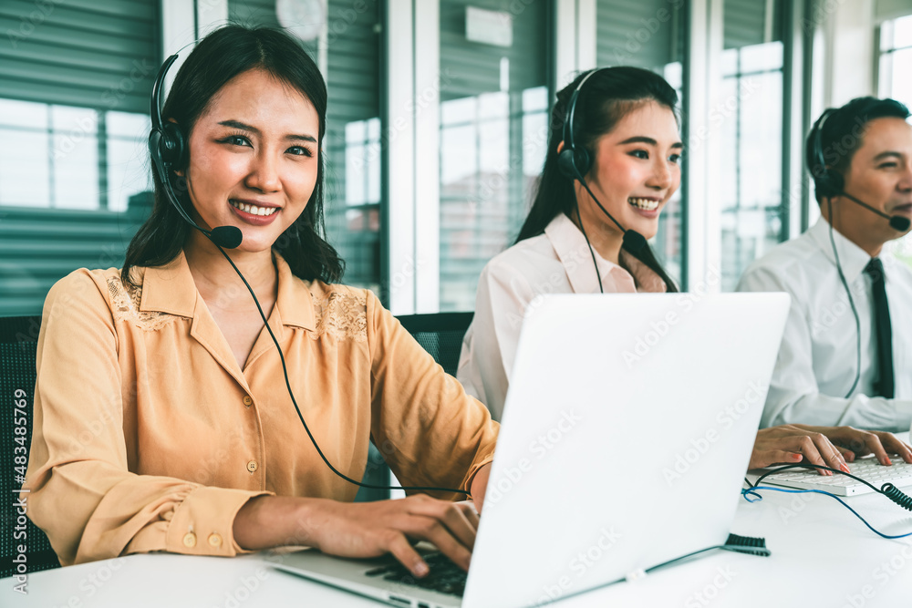 Business people wearing headset working actively in office . Call center, telemarketing, customer su