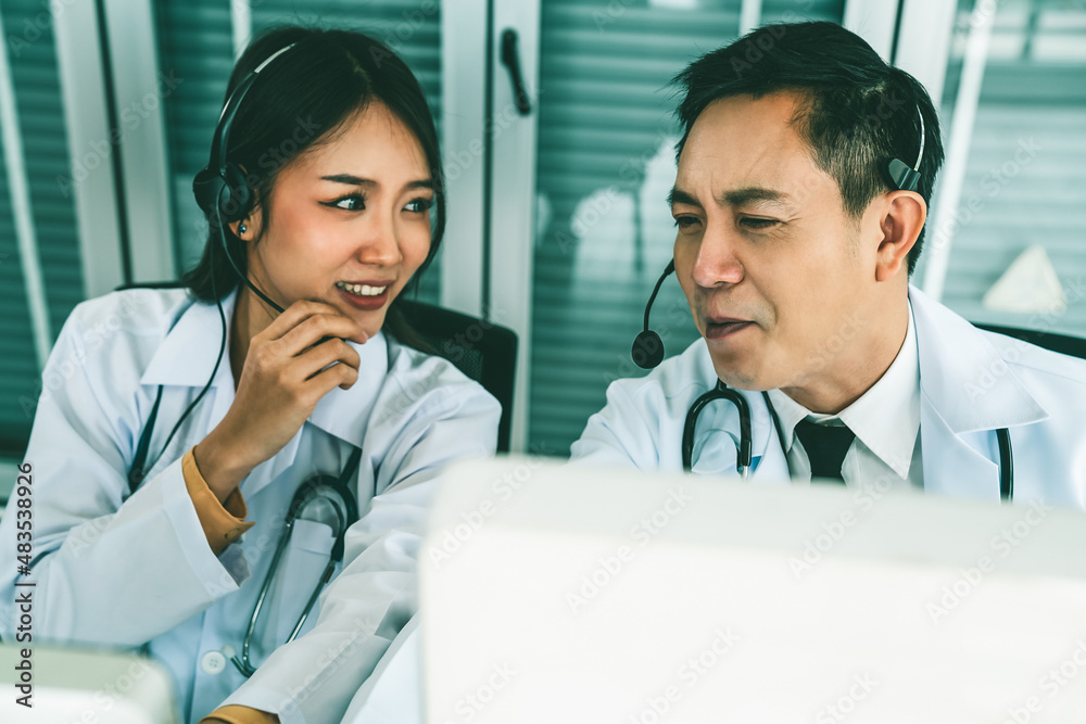 Doctor team wearing headset talking actively on video call in hospital clinic . Concept of telehealt