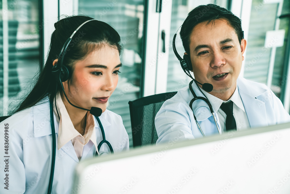 Doctor team wearing headset talking actively on video call in hospital clinic . Concept of telehealt