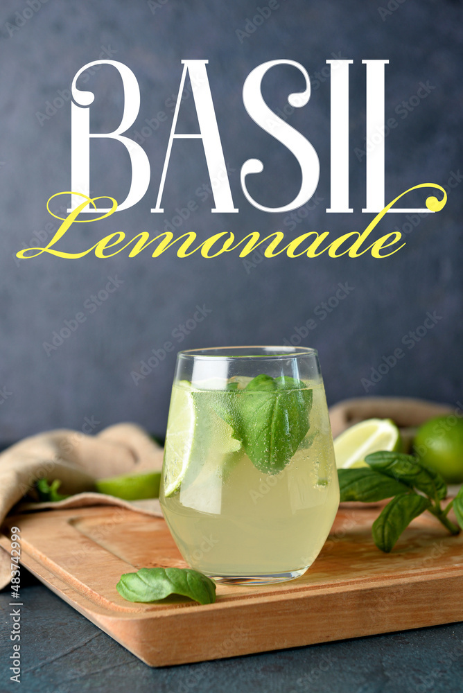 Glass of tasty basil lemonade on dark background