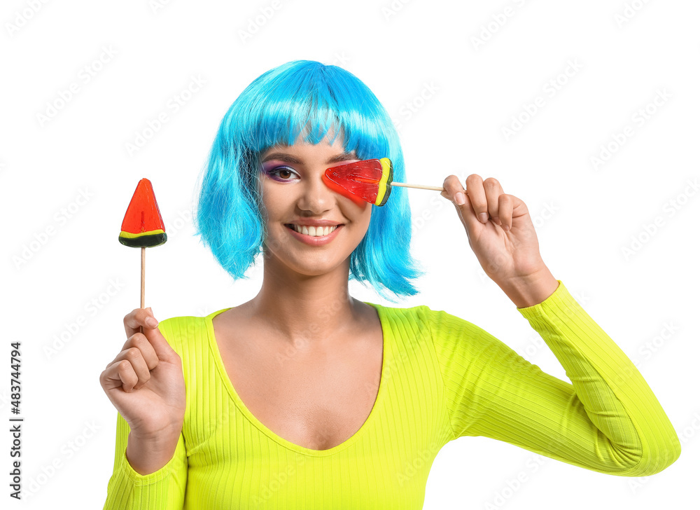 Young woman in blue wig with lollipops in shape of watermelon on white background