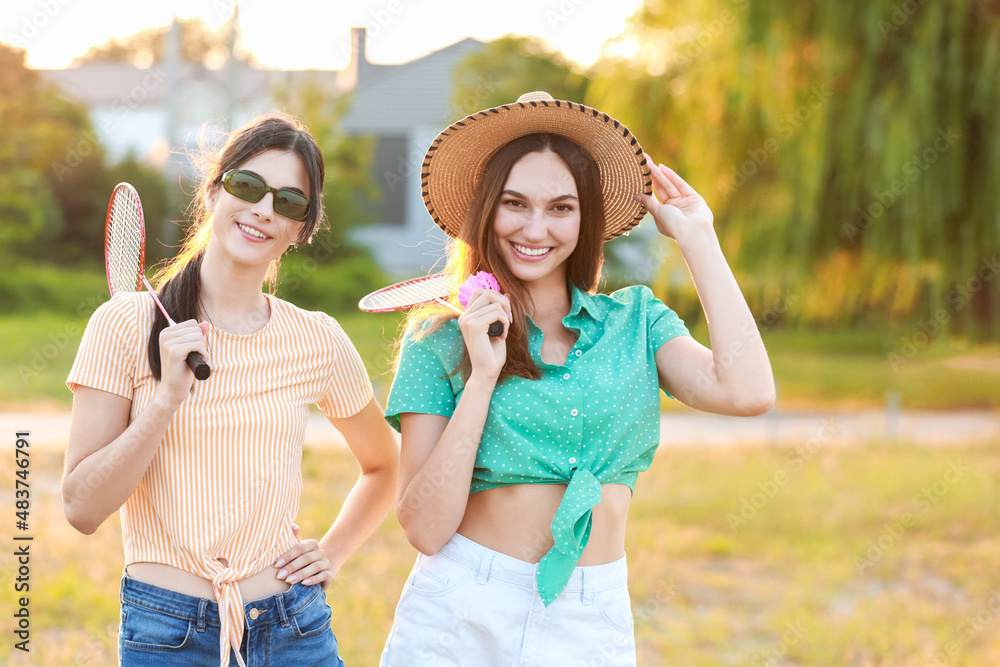 Female badminton players outdoors on summer day