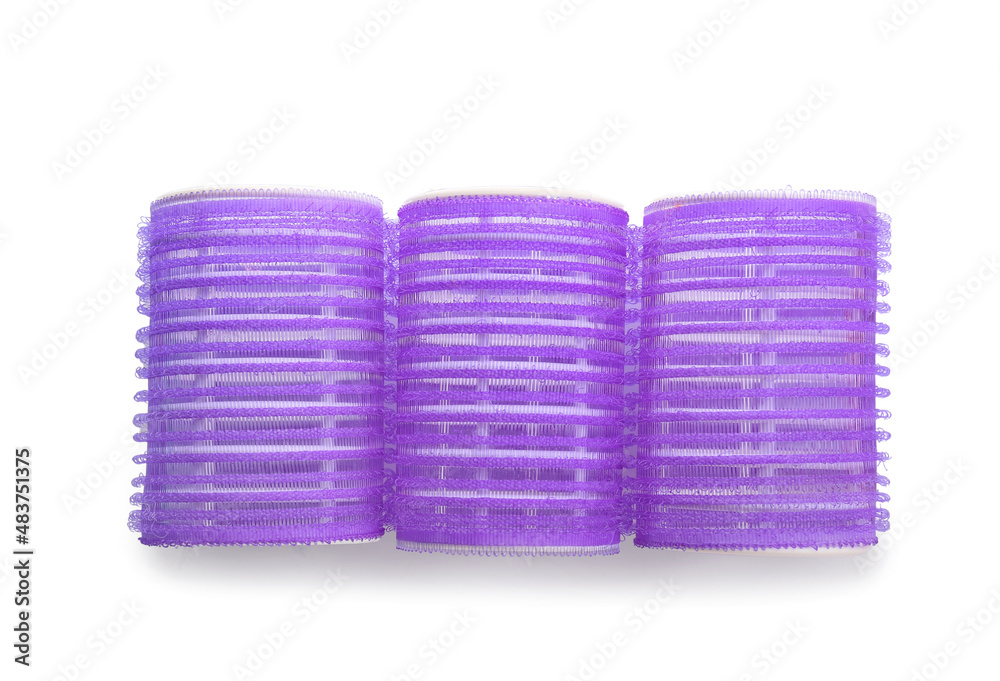 Purple hair curlers on light background