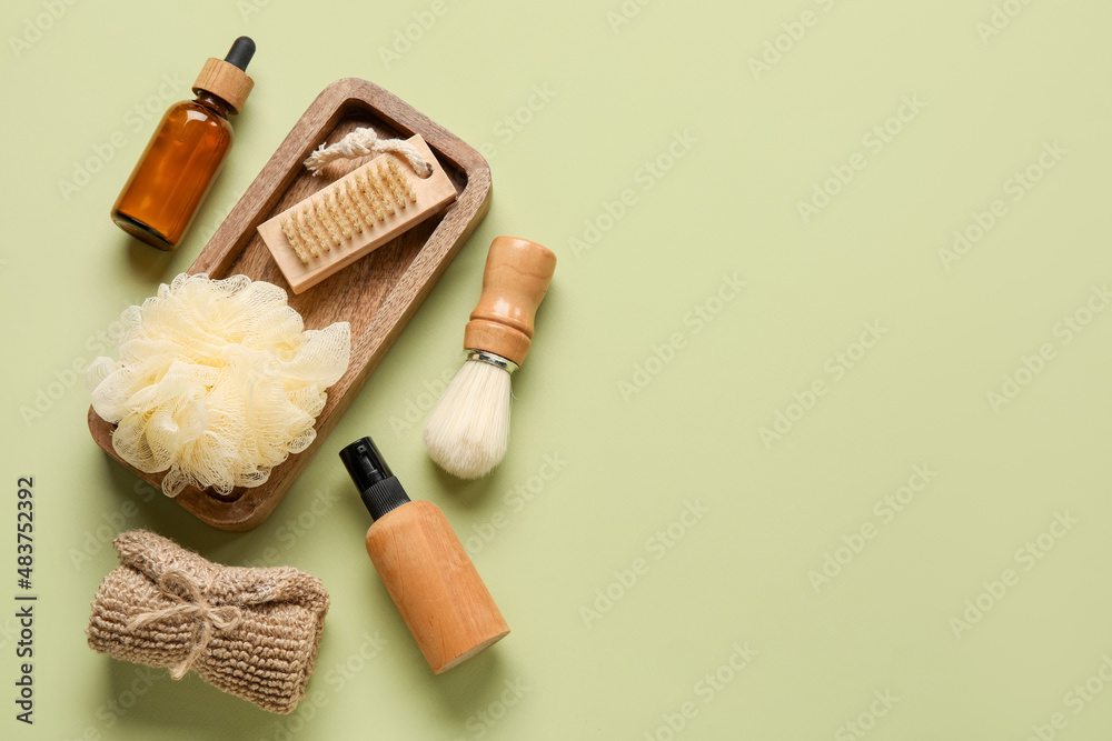 Set of bath supplies and cosmetics on green background