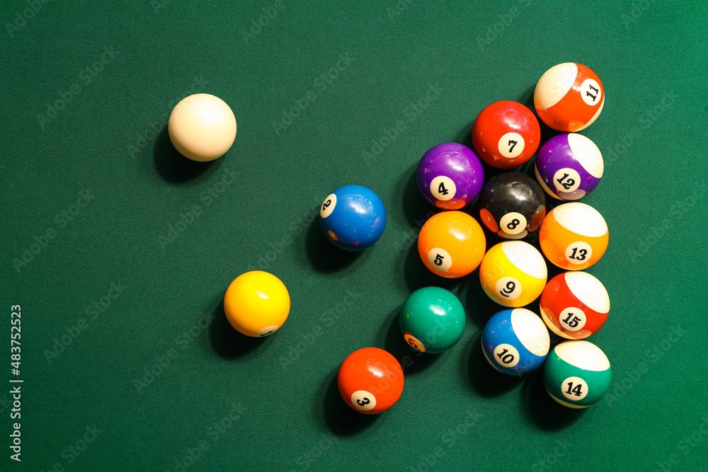 Different billiard balls on green table