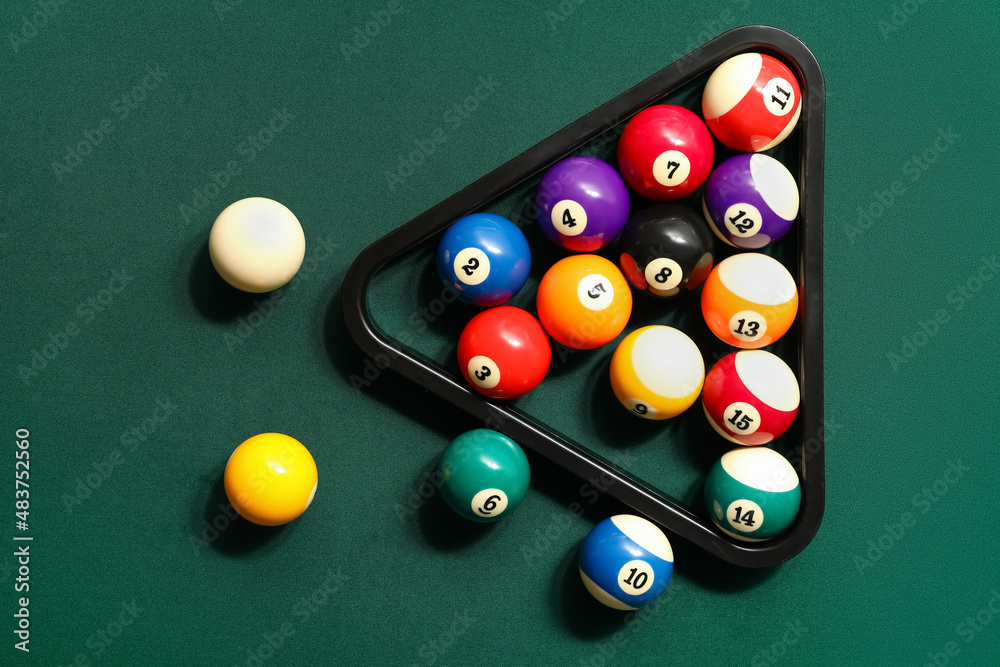 Rack with billiard balls on green table