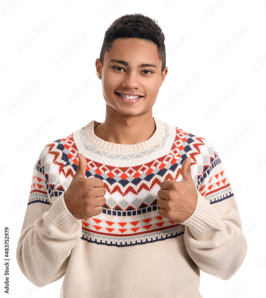 Handsome African-American guy in knitted sweater showing thumb-up on white background