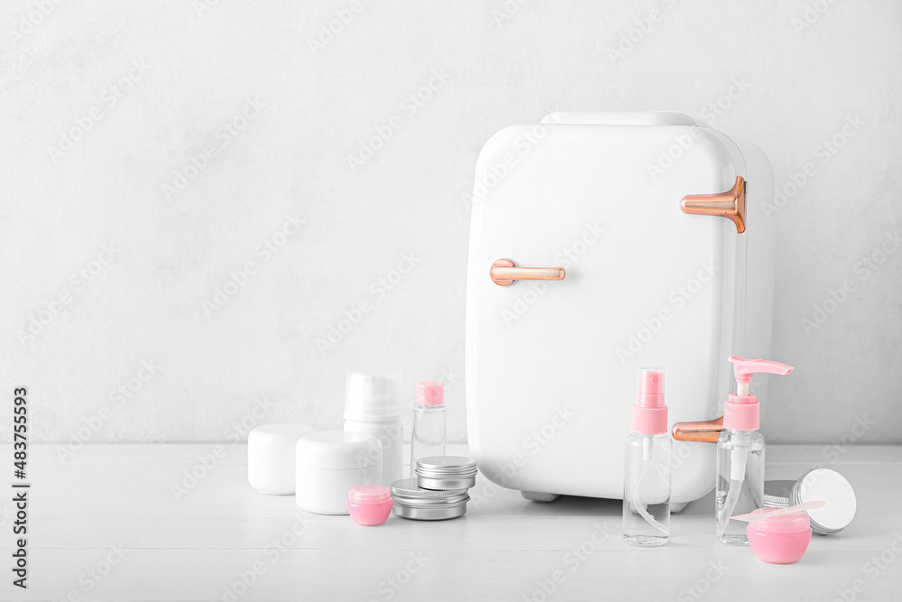 Small refrigerator and cosmetic products on light table