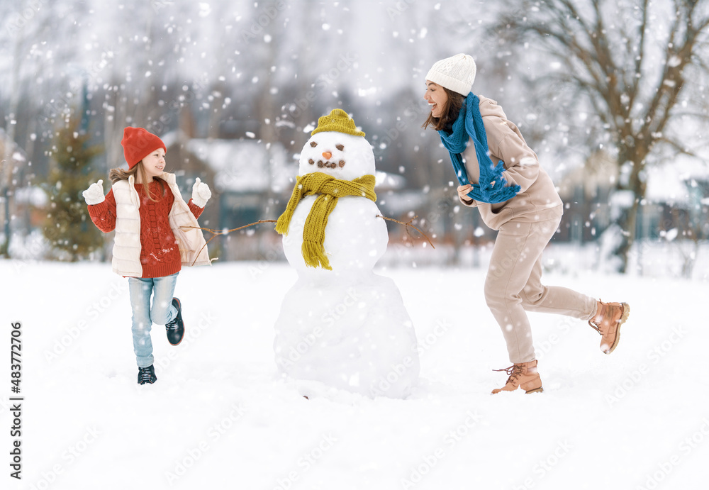 Mother and child girl on a winter walk