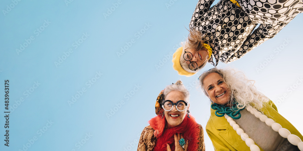 Low angle view of happy senior women smiling at the camera