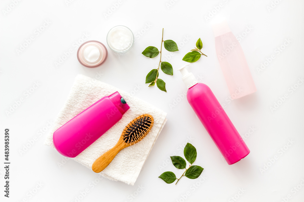 Flat lay of cosmetics for hair care with comb