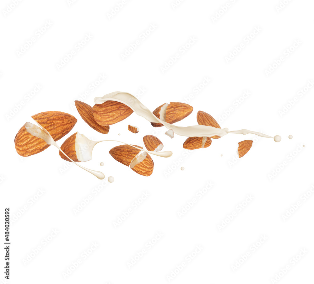 Crushed dried almonds with milk splashes in the air, isolated on a white background