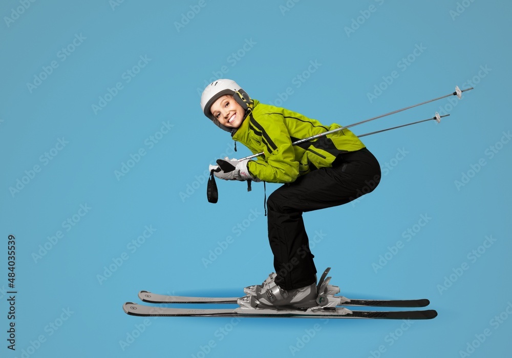 Full body skier smiling happy fun cool woman wearing warm jacket