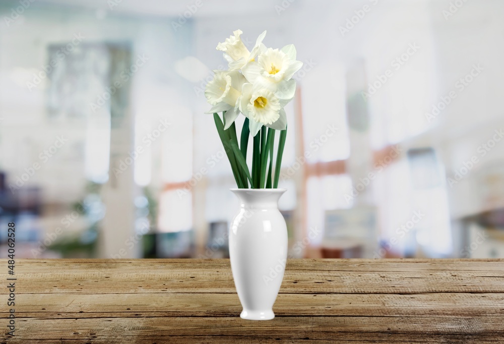 Autumn still life with garden flowers. Beautiful bouquet in a vase on wooden table.