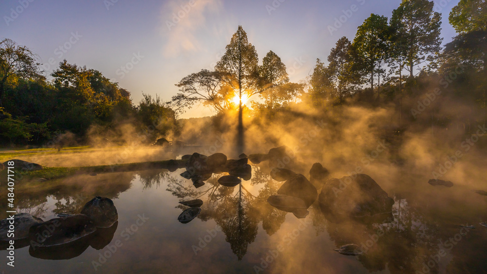 Hot springs and fog in Thailand with sunlight at morning, Sunrise above hot spring nature background