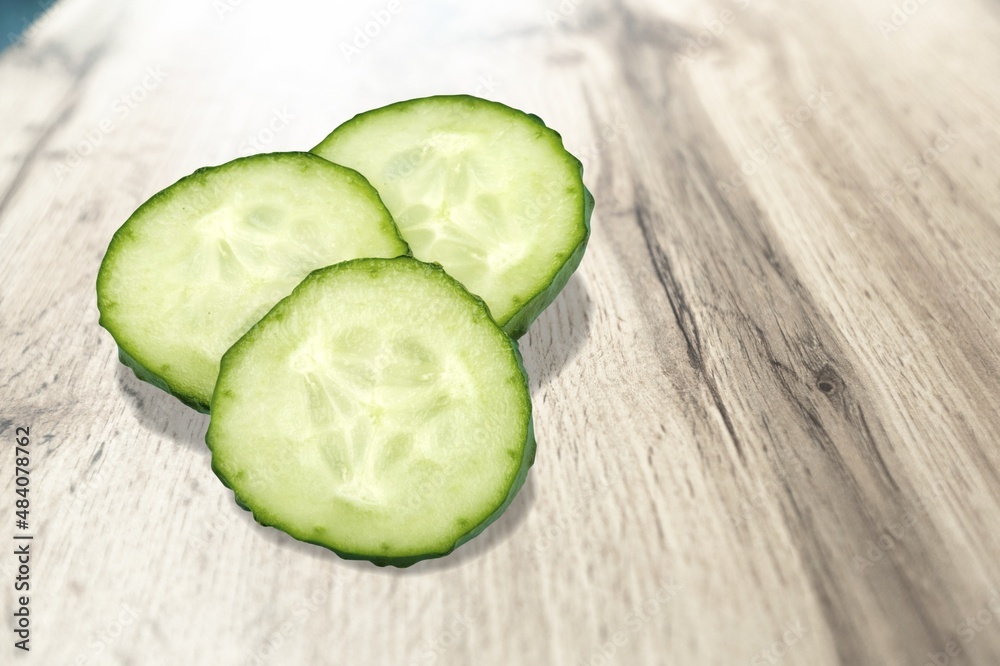 Slices of fresh ripe green cucumber on the desk