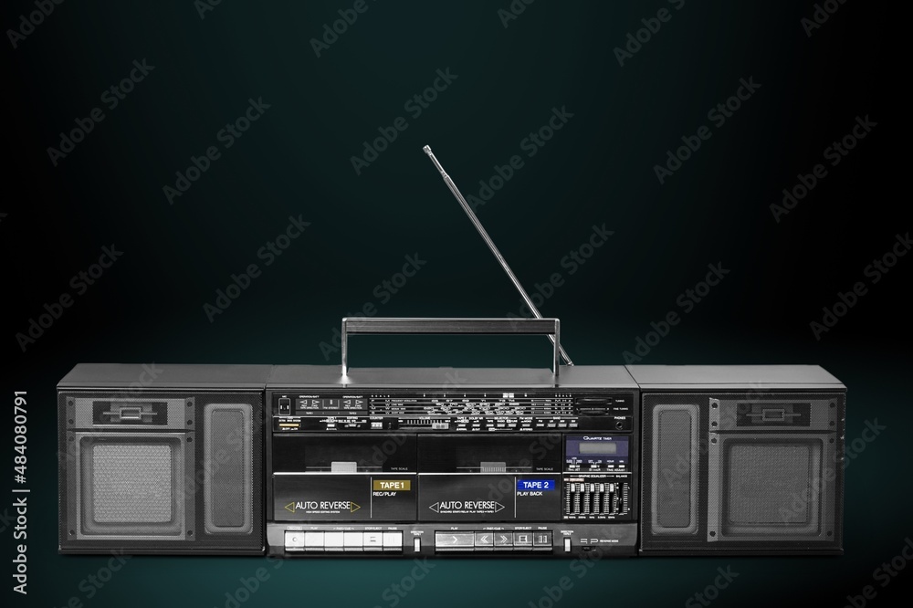 Retro vintage portable stereo cassette recorder from 80s on a background.