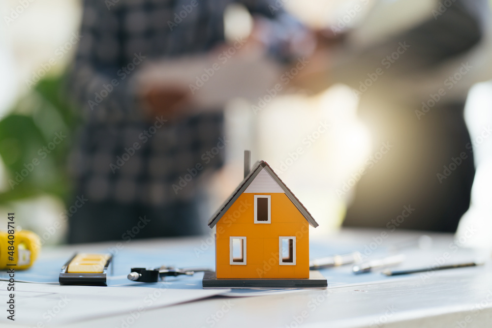 House model on table,Architect or engineer working in office with blueprints,engineer inspection in 