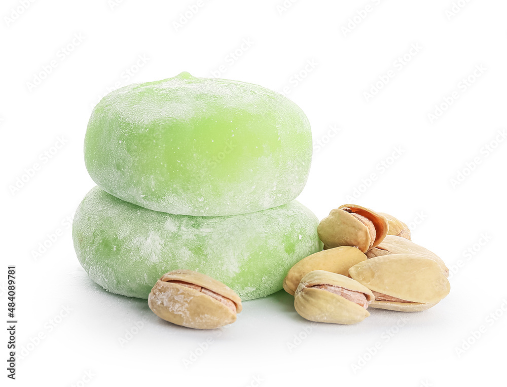 Delicious mochi and pistachios on white background