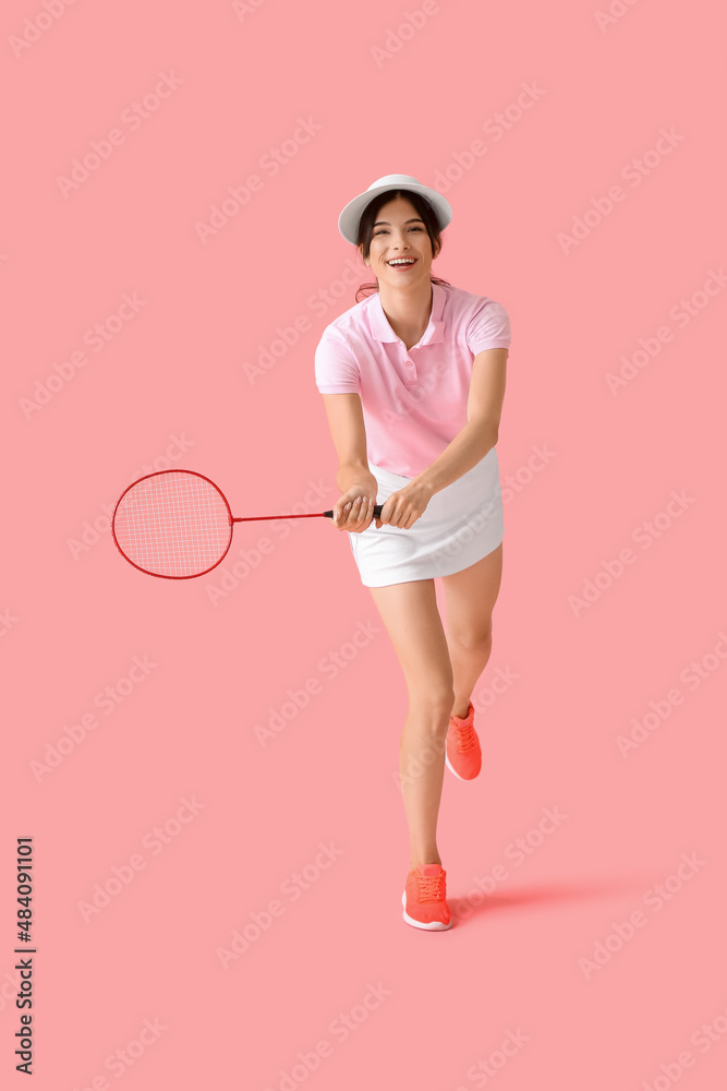 Sporty female badminton player on color background