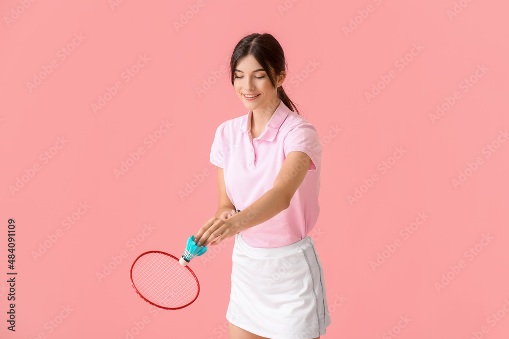 Sporty female badminton player on color background