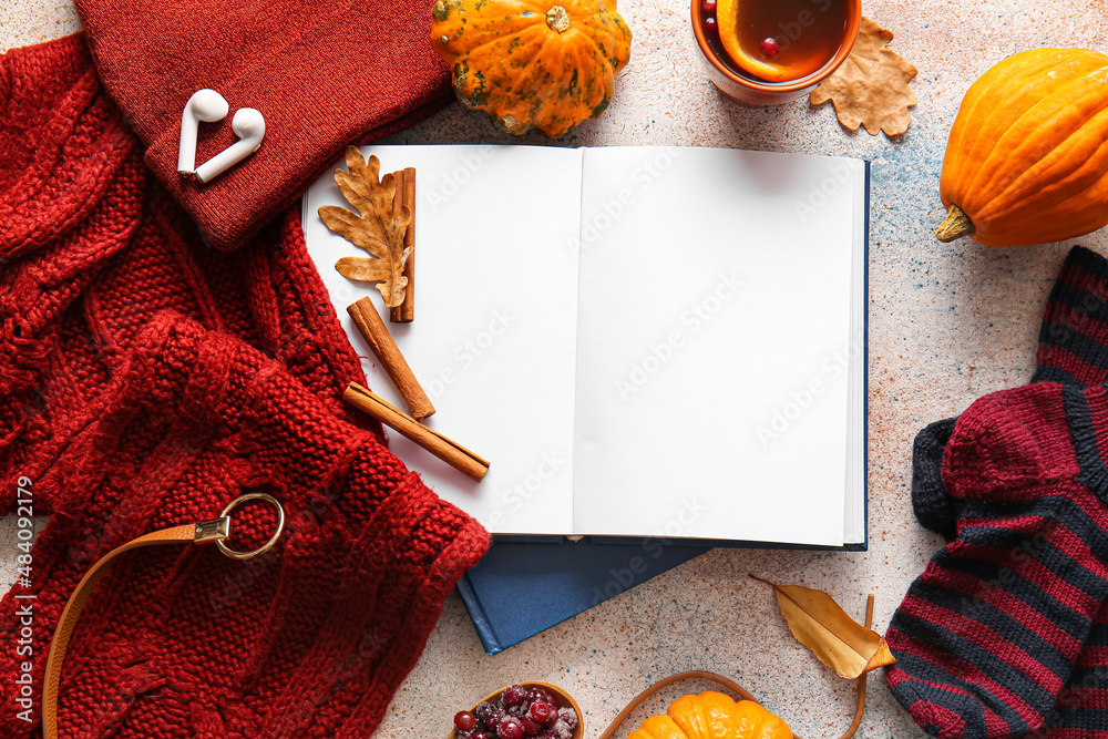 Blank book and autumn decor on light background