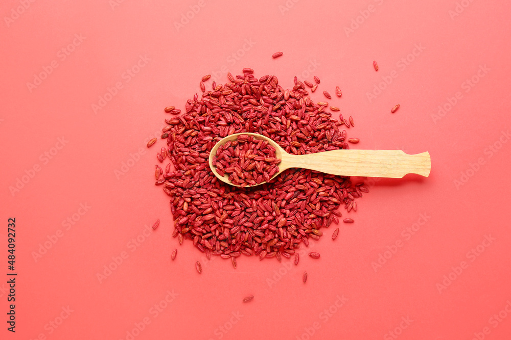 Spoon with dried barberries on red background