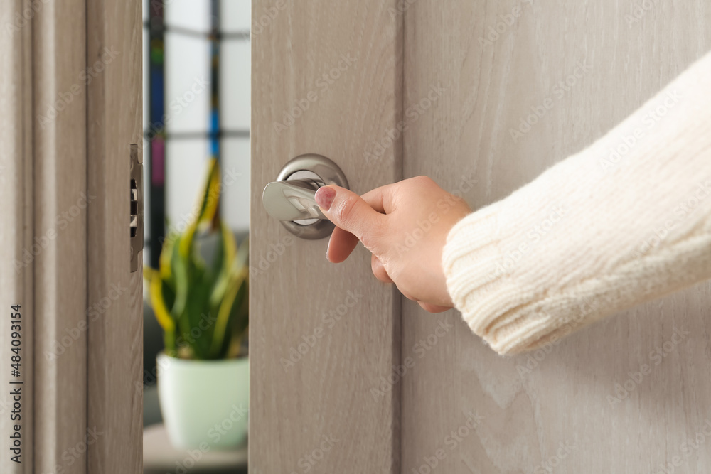 Woman opening light door at home, closeup