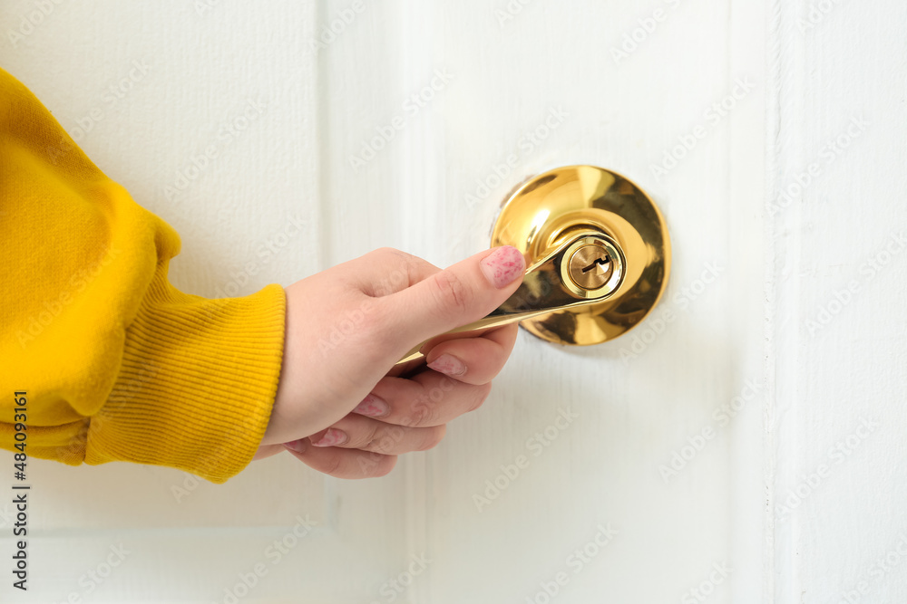 Woman opening light door at home, closeup