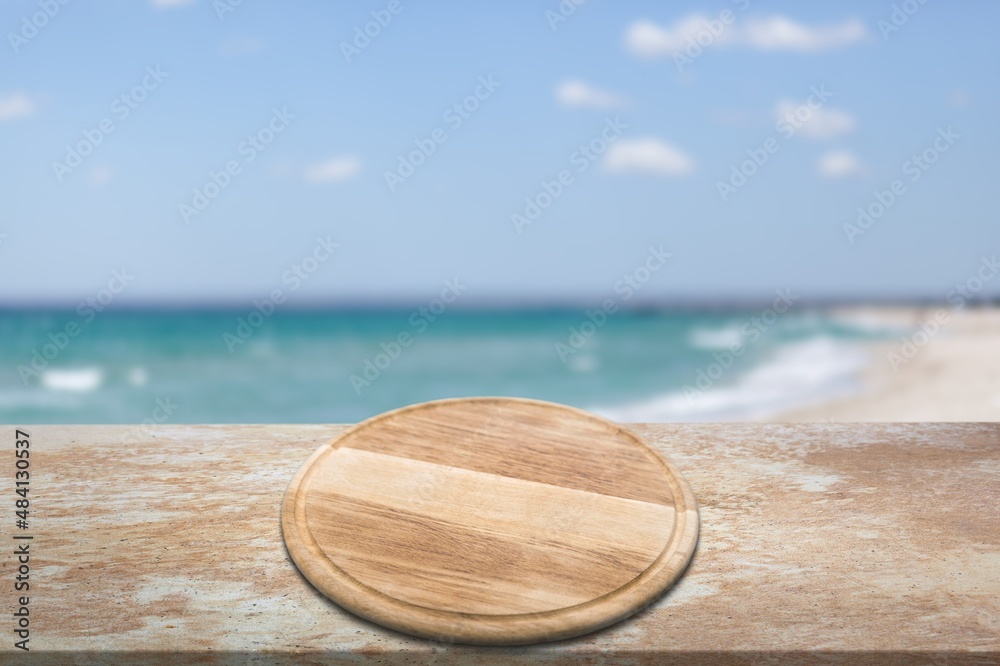 Wooden platform on the table for standing product against the background of the sea landscape