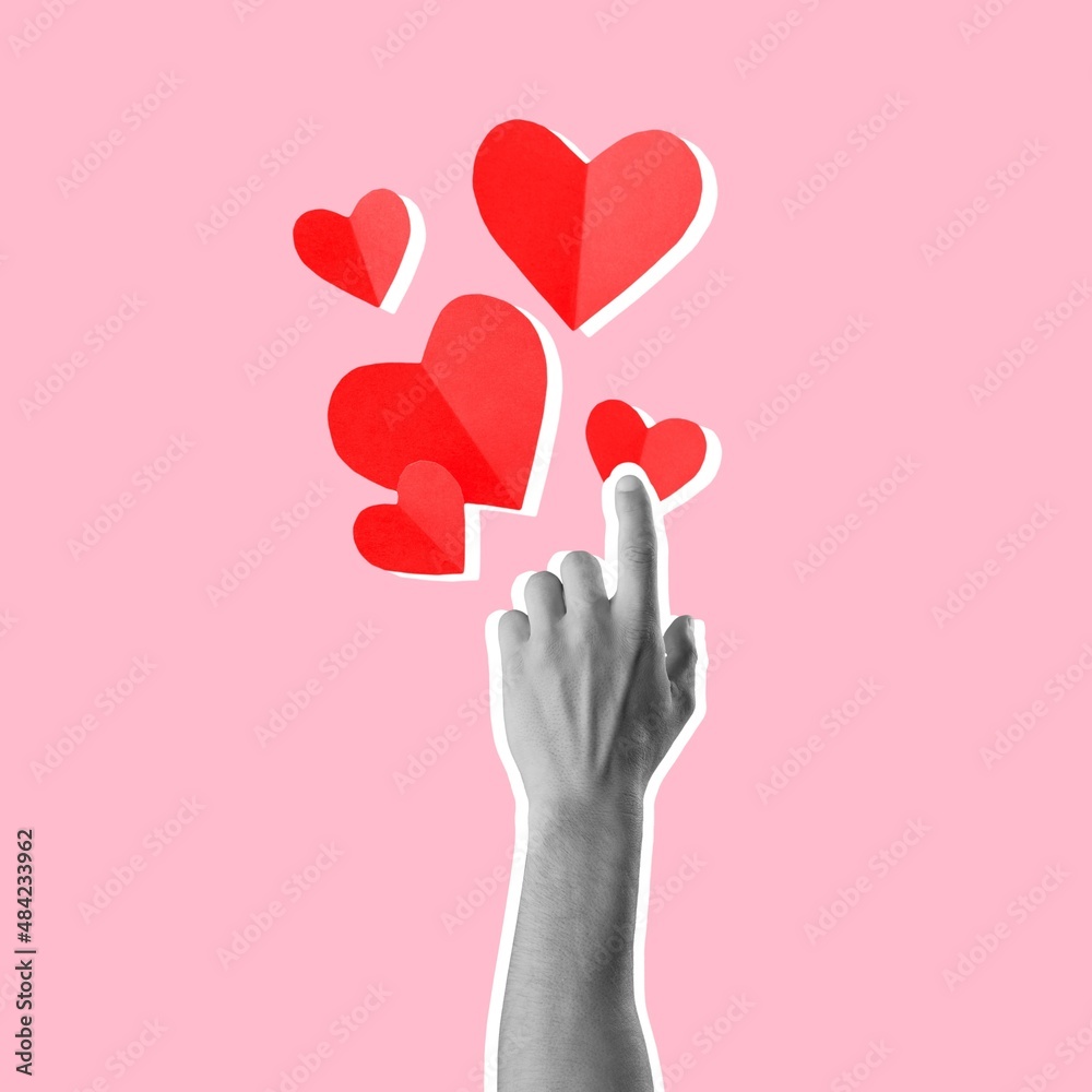 Red paper hearts and hand on a pastel background