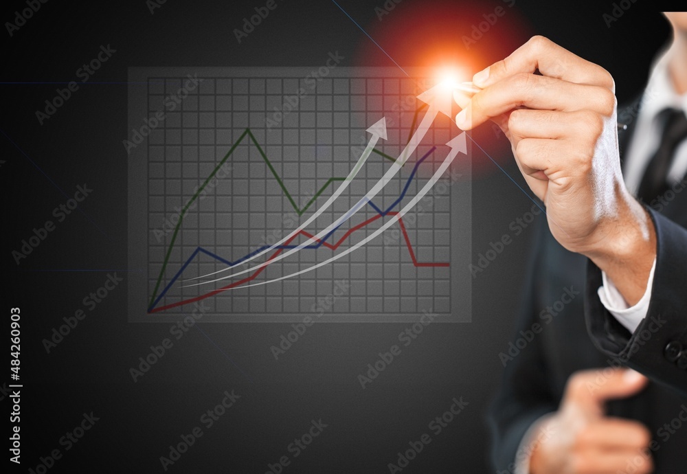 Analyzing and data exchange. Businessman draws growth graph of business. Business strategy