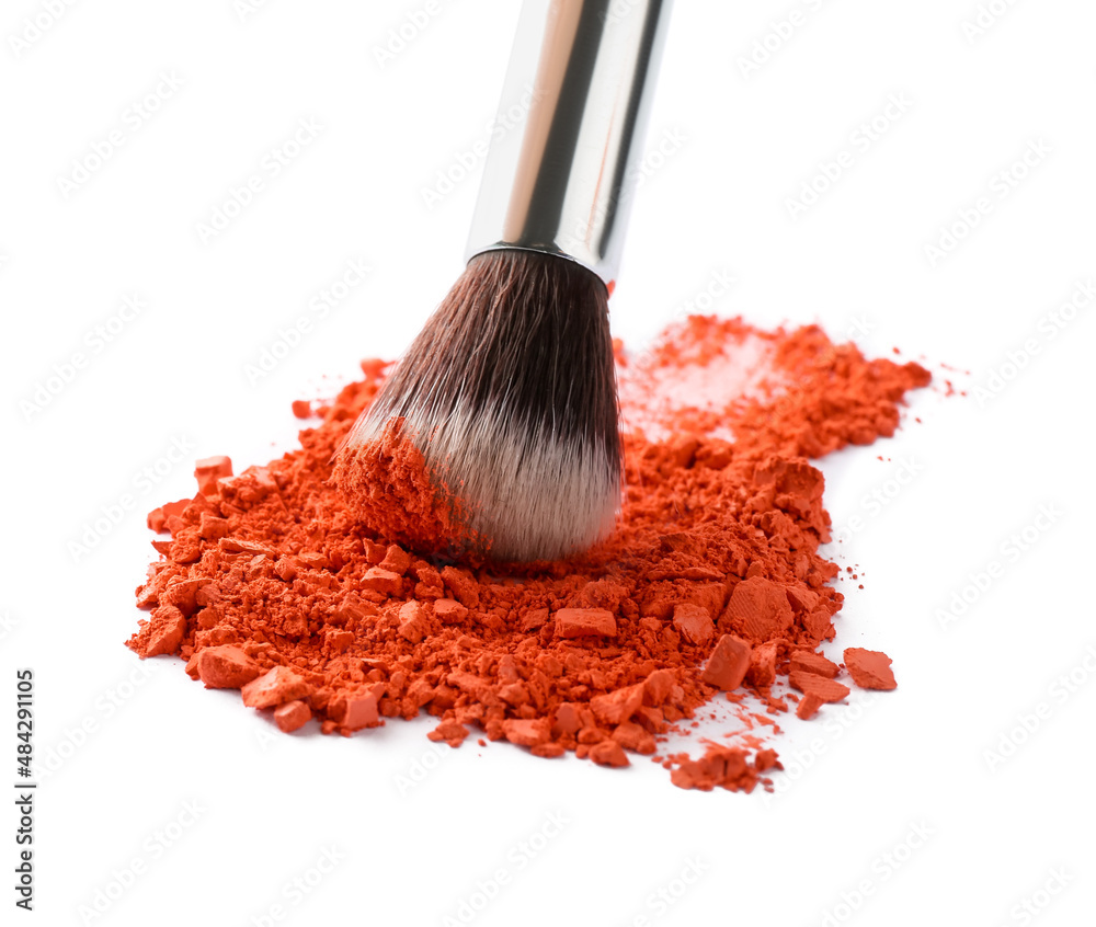 Makeup brush and loose eye shadow on white background