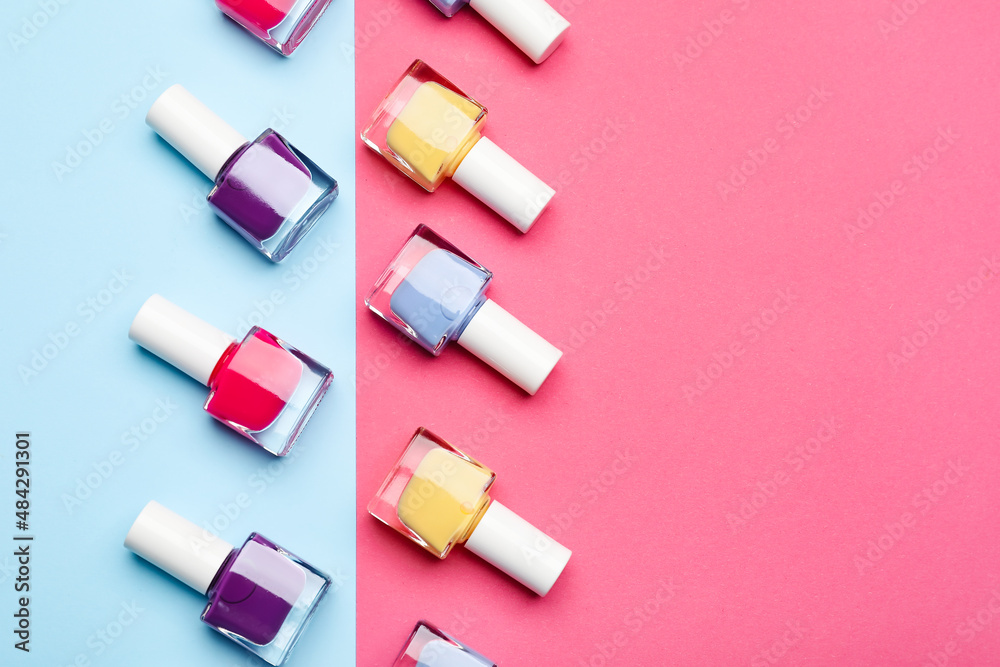 Set of nail polish bottles on color background