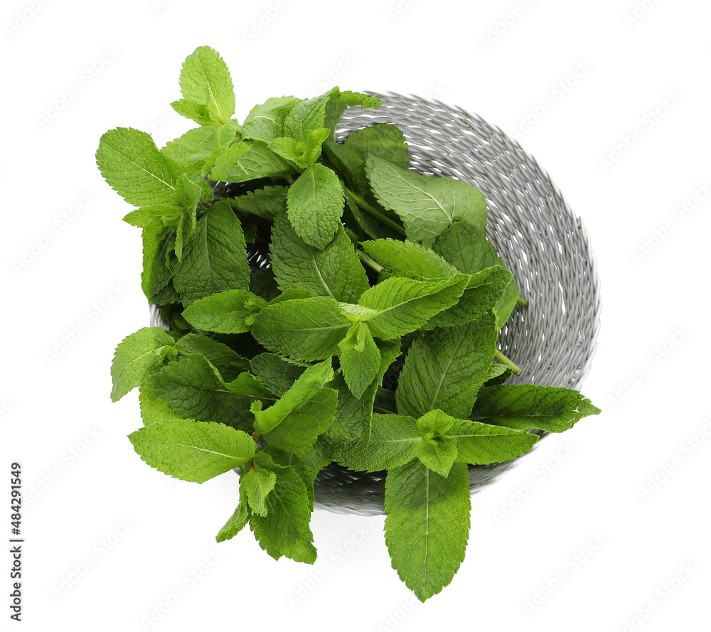 Wicker bowl with mint on white background